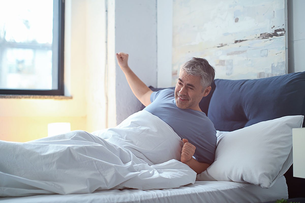 Image of a man waking up from sleeping