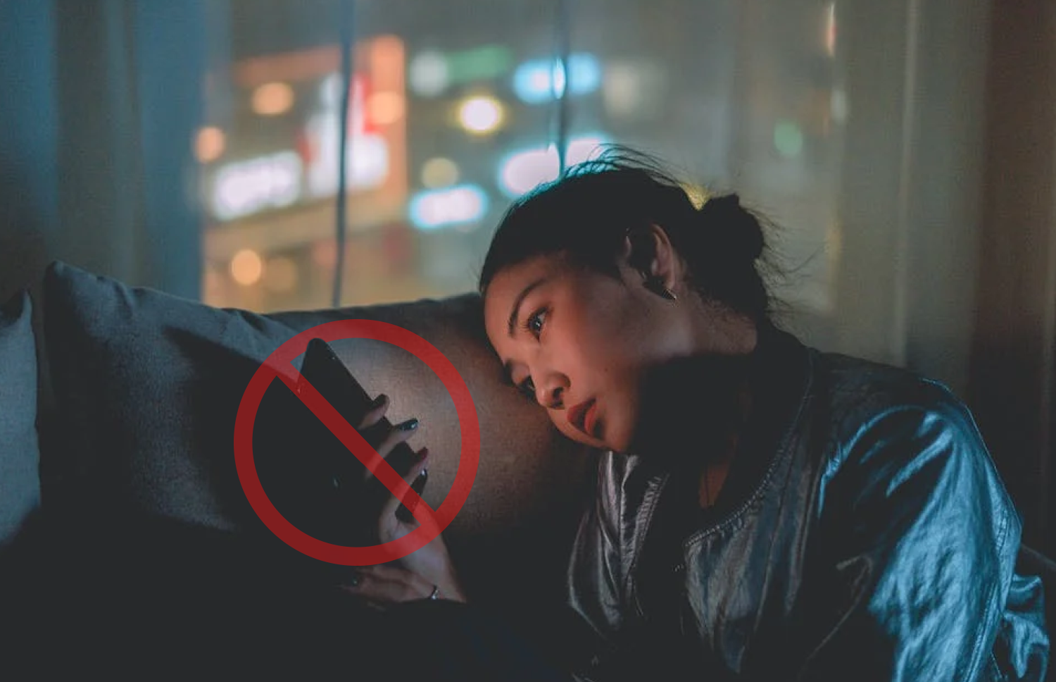 Woman watching her phone at night